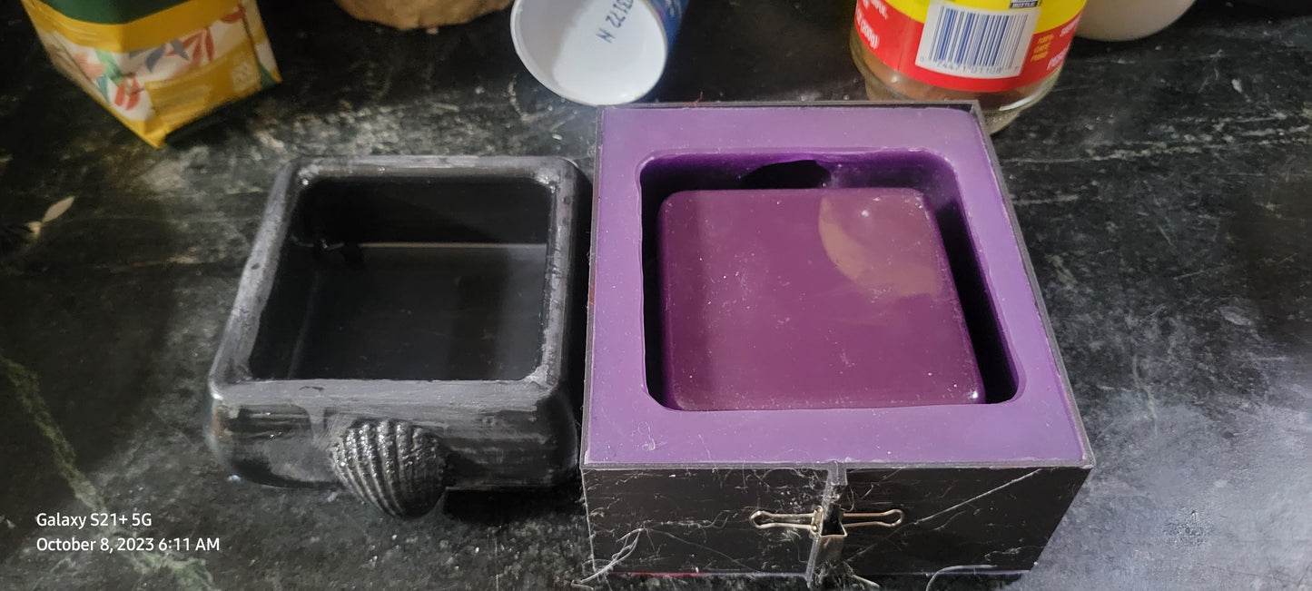 Square candle mold with shell.